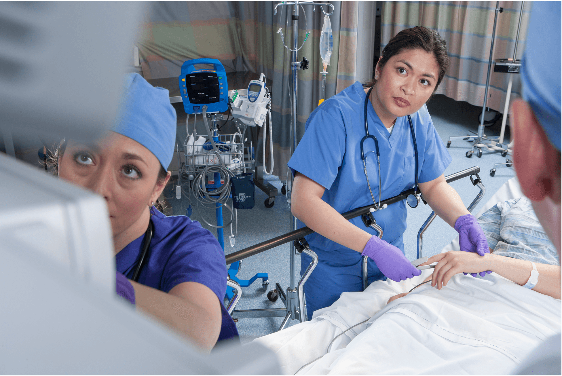 ICU nurse performing manual urine output measurement